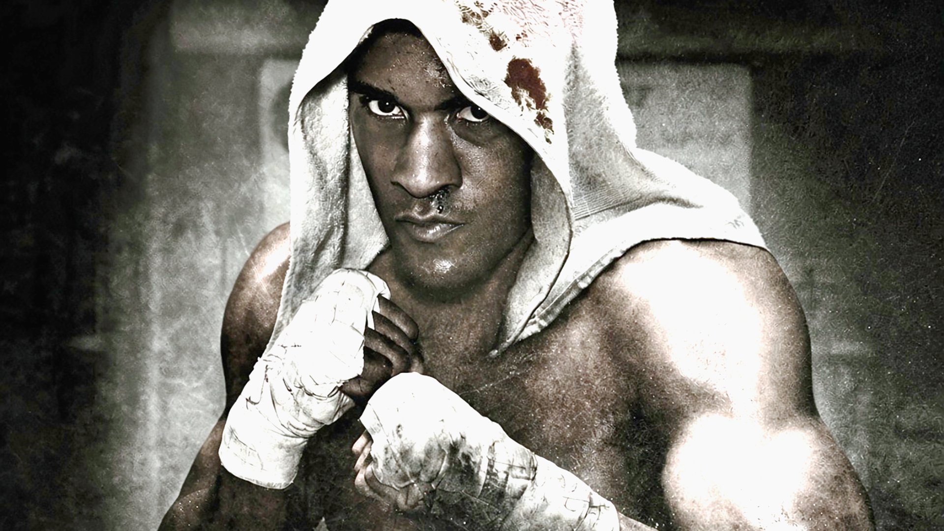 Fight Night Champion key art of boxer Andre Bishop in a hooded towel with wrapped fists